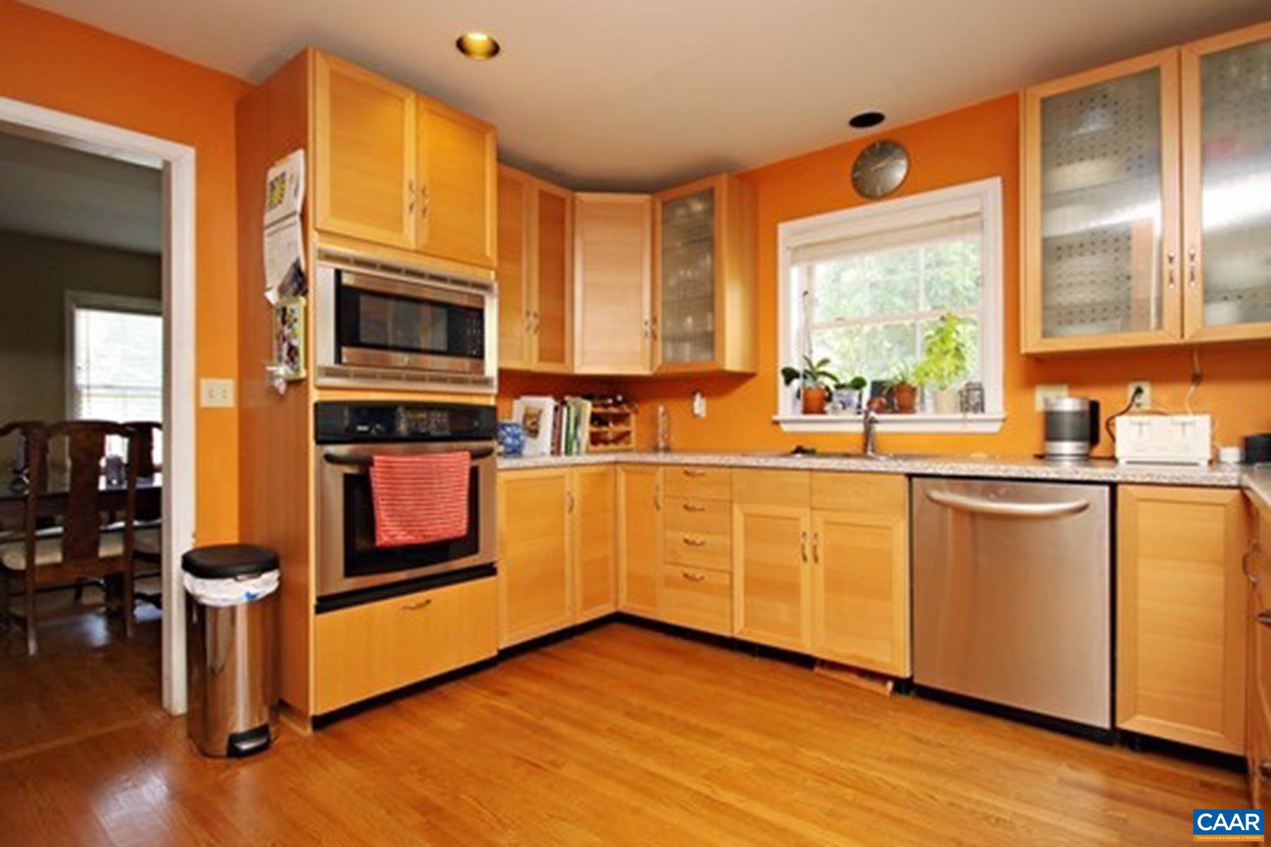755 King Street, Unit A Charlottesville, VA 22903 - Photo 6 of 13 a kitchen with stainless steel appliances a sink cabinets and wooden floor