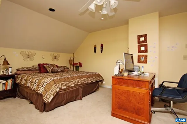 a bedroom with a bed and a desk