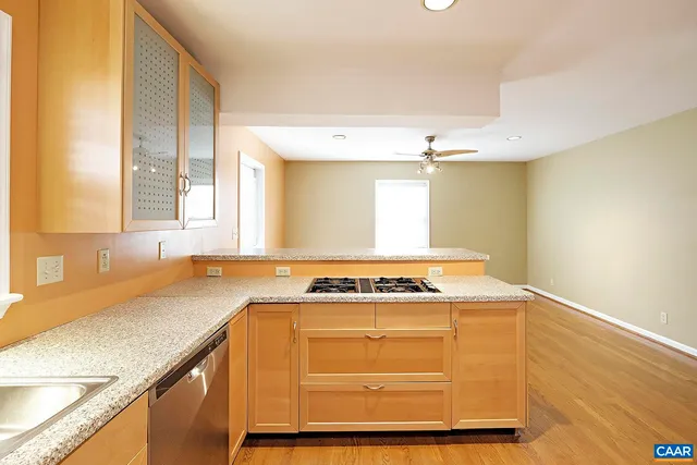 a view of a kitchen with a sink and dishwasher next to a window