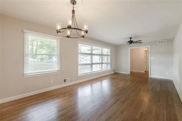 a kitchen with granite countertop a refrigerator stove top oven and sink