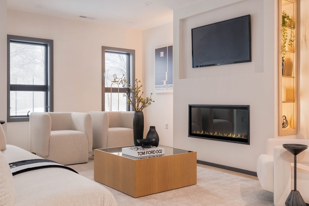 31 Highland Road, Unit 1 Brookline, MA 02445 - Photo 11 of 34 a living room with furniture a flat screen tv and a fireplace