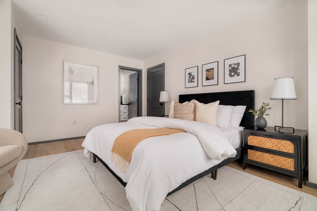 31 Highland Road, Unit 1 Brookline, MA 02445 - Photo 17 of 34 a bedroom with a bed and a lamp on table