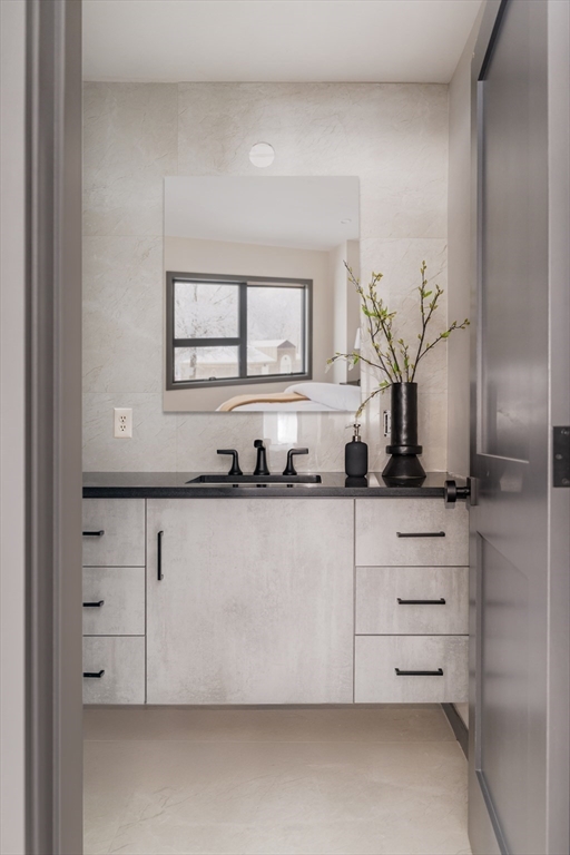 31 Highland Road, Unit 1 Brookline, MA 02445 - Photo 18 of 34 a bathroom with a sink and a mirror