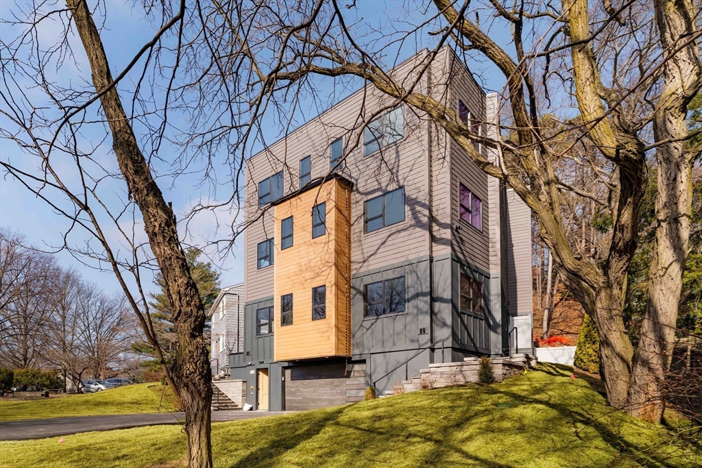 31 Highland Road, Unit 1 Brookline, MA 02445 - Photo 34 of 34 a backyard of a building with trees