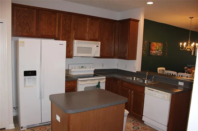a kitchen with stainless steel appliances a refrigerator sink and cabinets