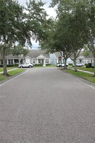 a view of a street with a house in the background