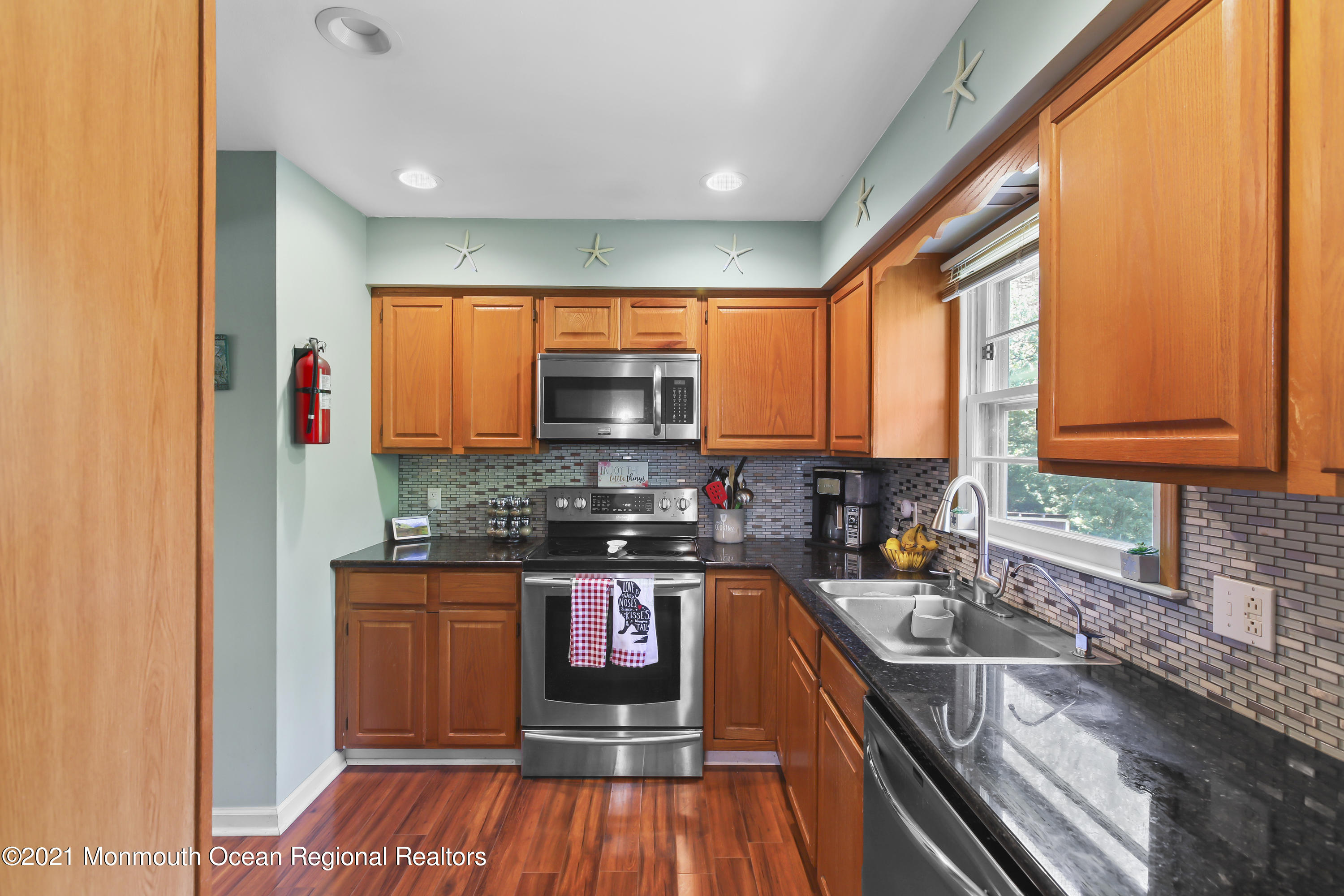 401 Cedar Swamp Road Jackson, NJ 08527 - Photo 6 of 22 a kitchen with stainless steel appliances granite countertop sink stove microwave refrigerator and cabinets