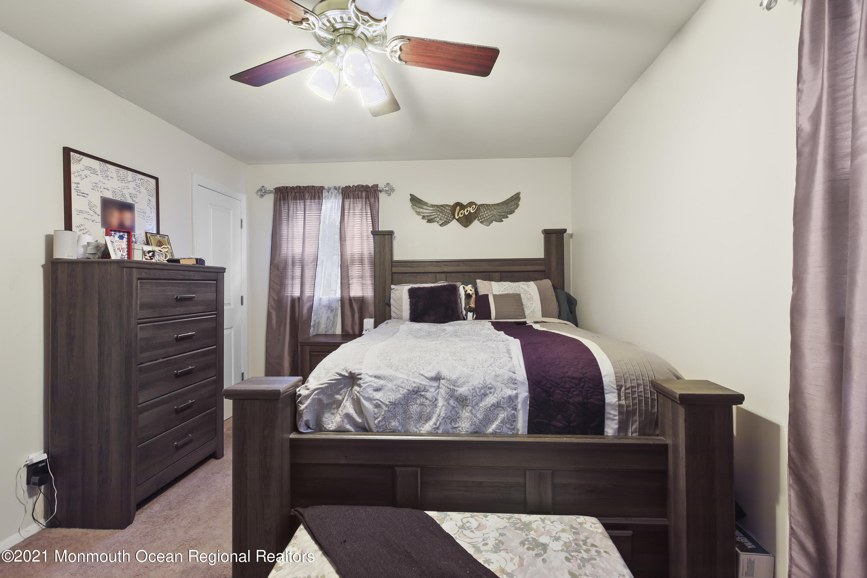 401 Cedar Swamp Road Jackson, NJ 08527 - Photo 8 of 22 a bedroom with a bed and a chandelier