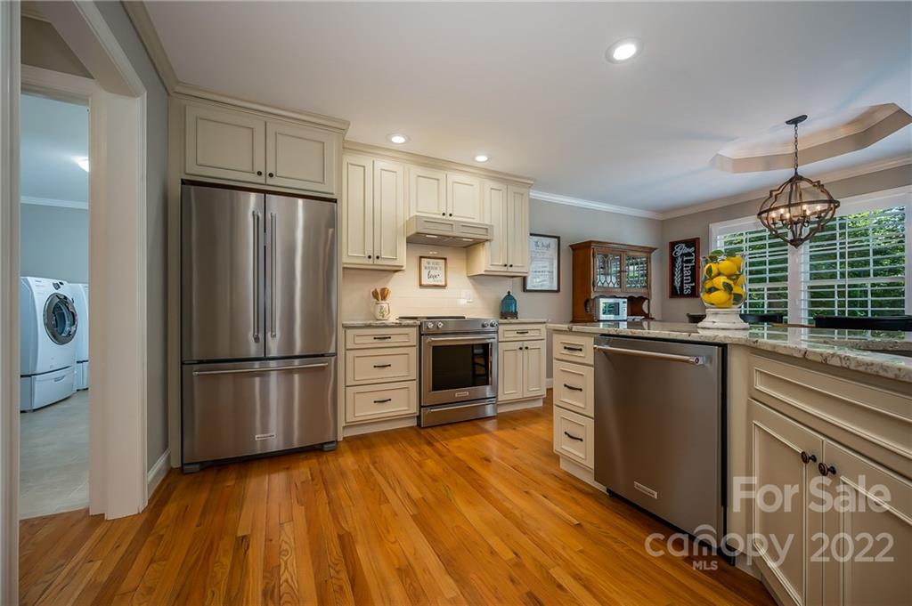 212 Ridgeview Drive Rutherfordton, NC 28139 - Photo 14 of 47 a kitchen with refrigerator a stove and wooden floor