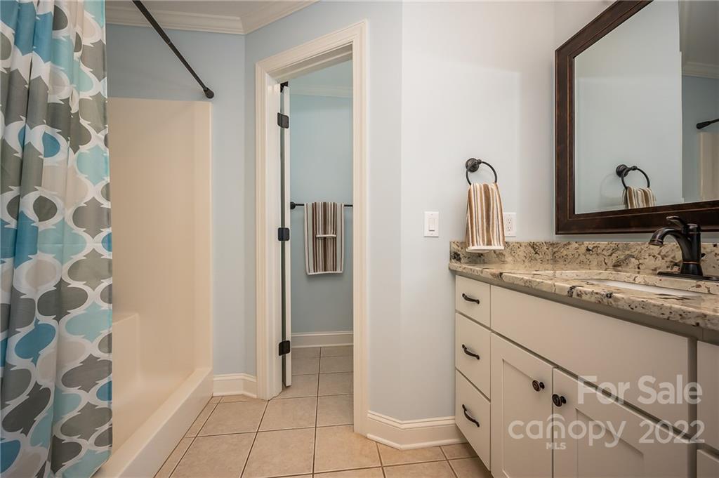 212 Ridgeview Drive Rutherfordton, NC 28139 - Photo 17 of 47 a bathroom with a granite countertop sink a mirror and a shower