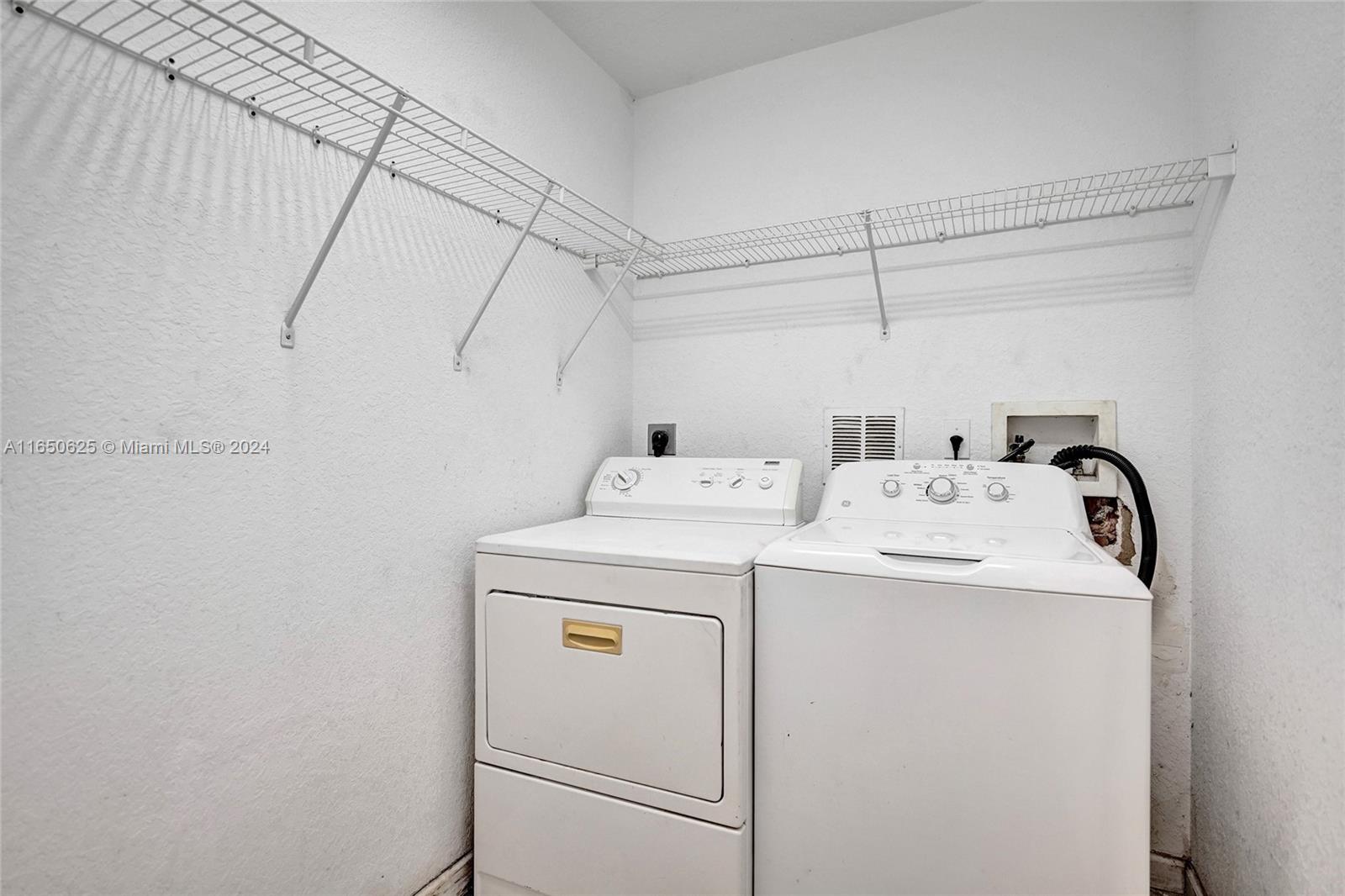 6073 Spring Isles Boulevard Lake Worth, FL 33463 - Photo 20 of 66 a utility room with dryer and washer