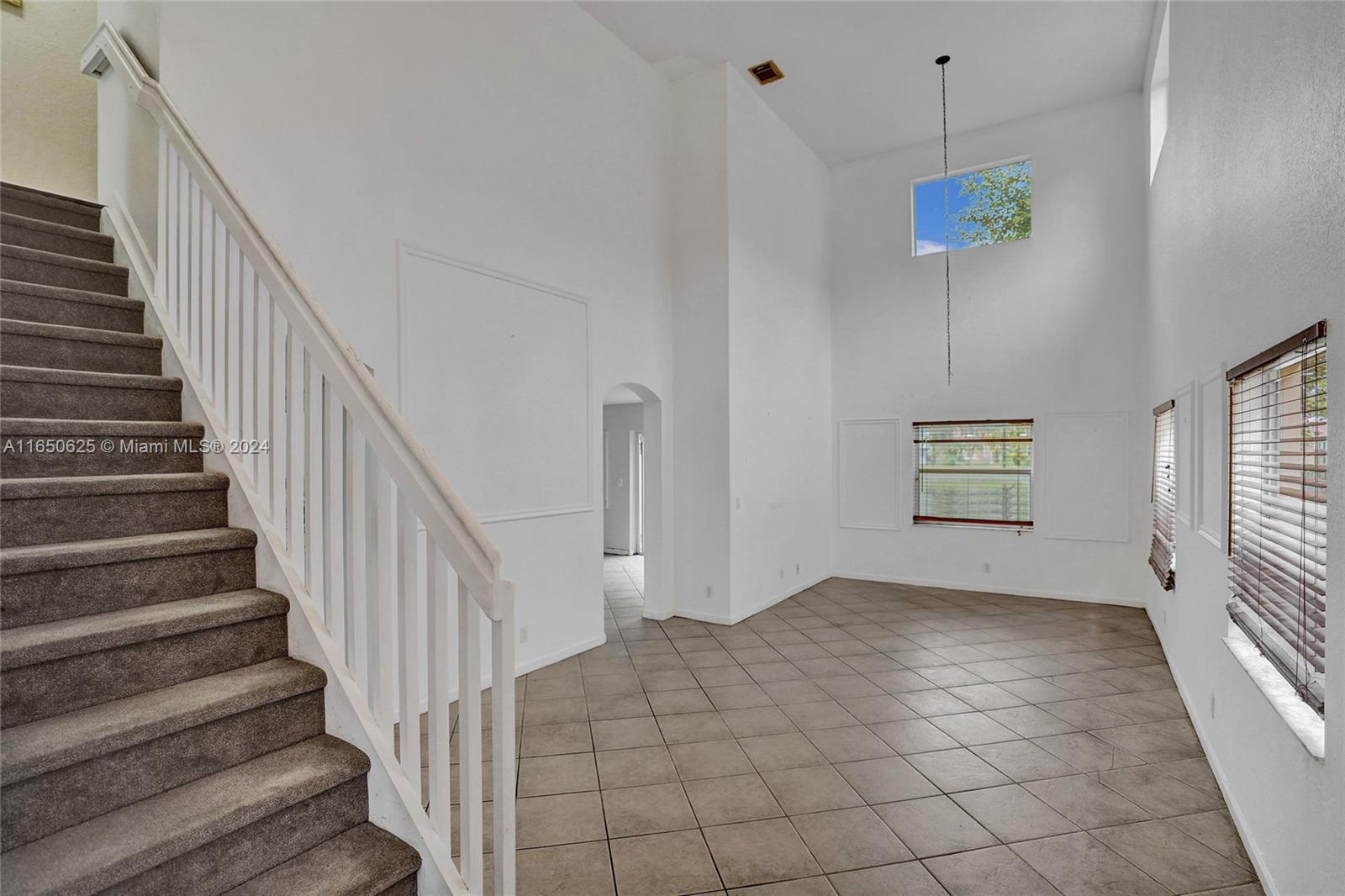 6073 Spring Isles Boulevard Lake Worth, FL 33463 - Photo 2 of 66 a view of an entryway with staircase