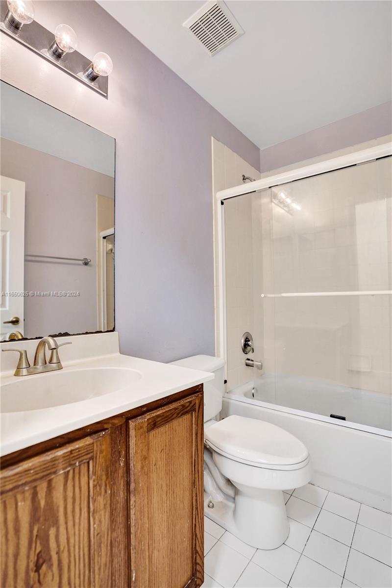 6073 Spring Isles Boulevard Lake Worth, FL 33463 - Photo 25 of 66 a bathroom with a sink a toilet and shower
