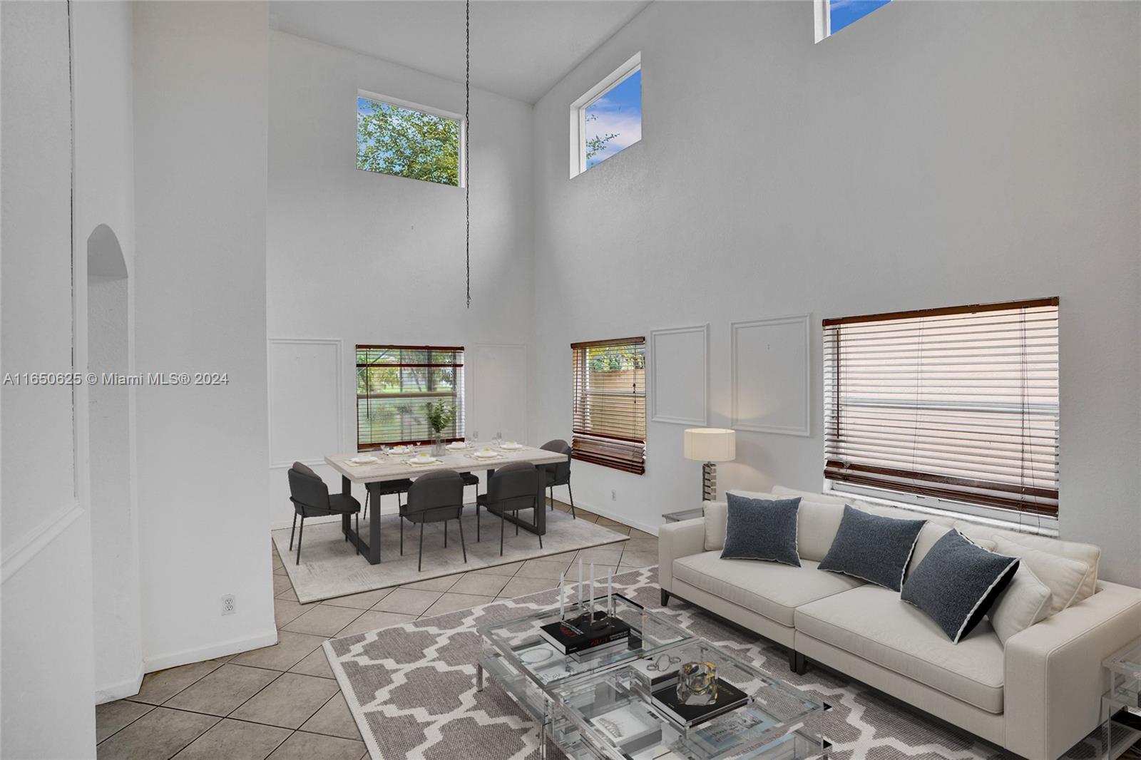 6073 Spring Isles Boulevard Lake Worth, FL 33463 - Photo 3 of 66 a living room with furniture a rug and a window