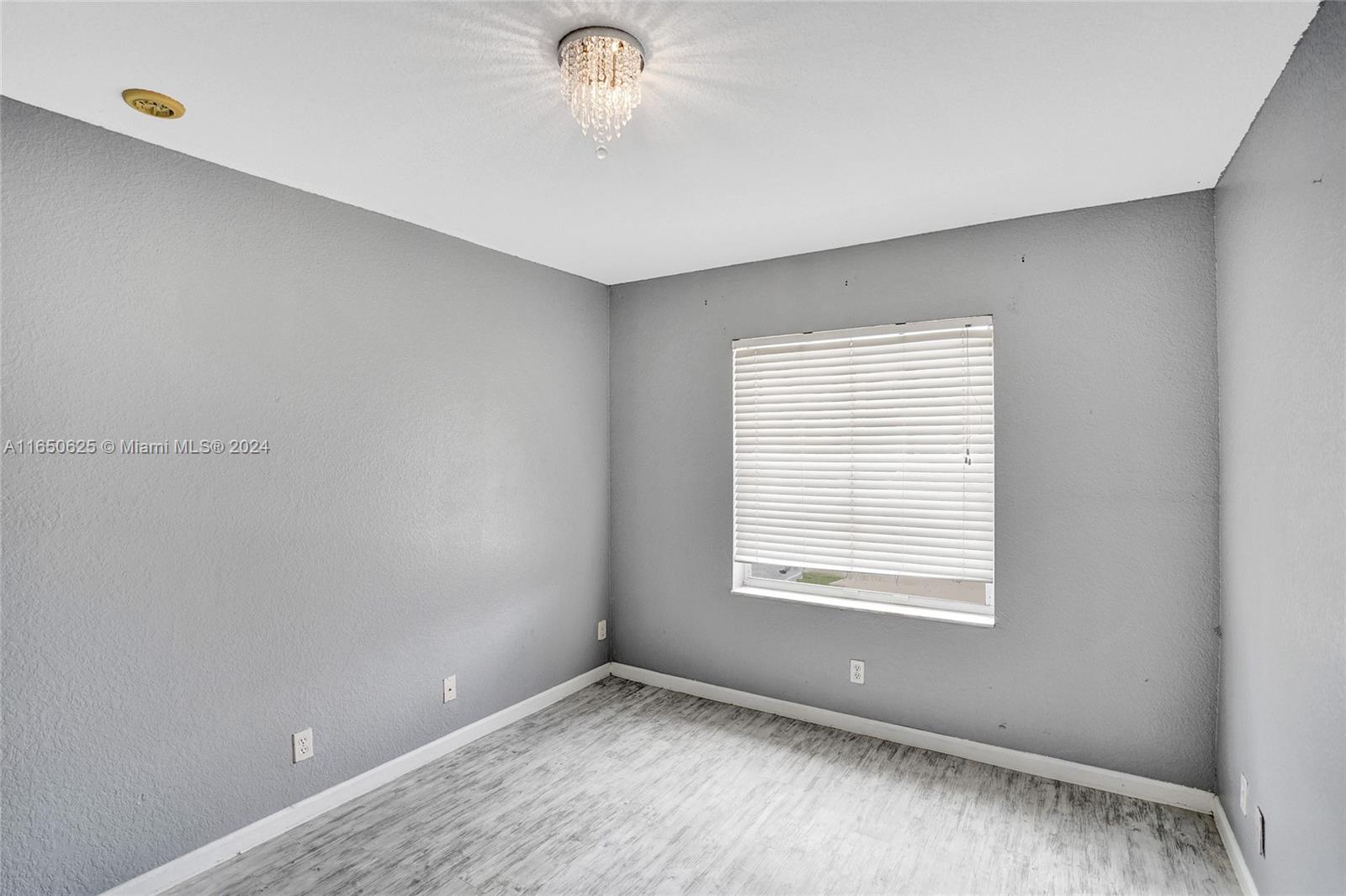 6073 Spring Isles Boulevard Lake Worth, FL 33463 - Photo 32 of 66 a view of an empty room with a window