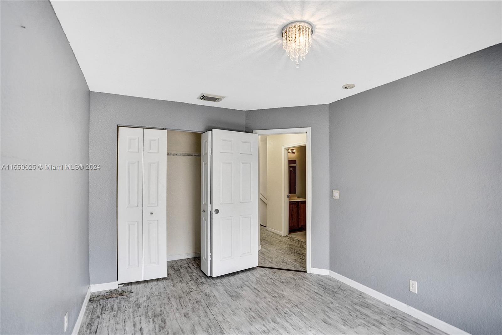 6073 Spring Isles Boulevard Lake Worth, FL 33463 - Photo 33 of 66 a view of room with hardwood floor and ceiling fan