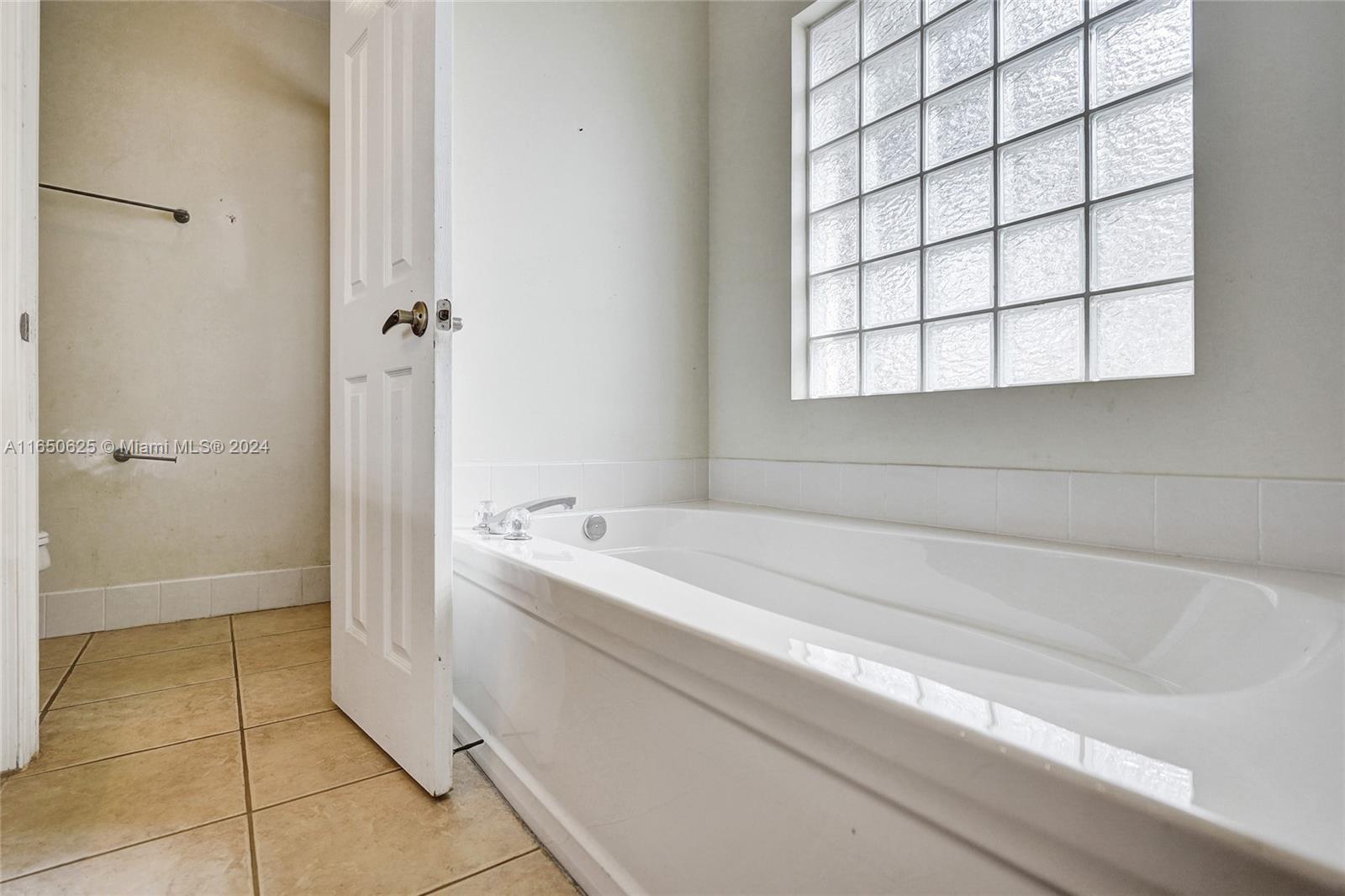 6073 Spring Isles Boulevard Lake Worth, FL 33463 - Photo 38 of 66 a spacious bathroom with a bathtub and sink