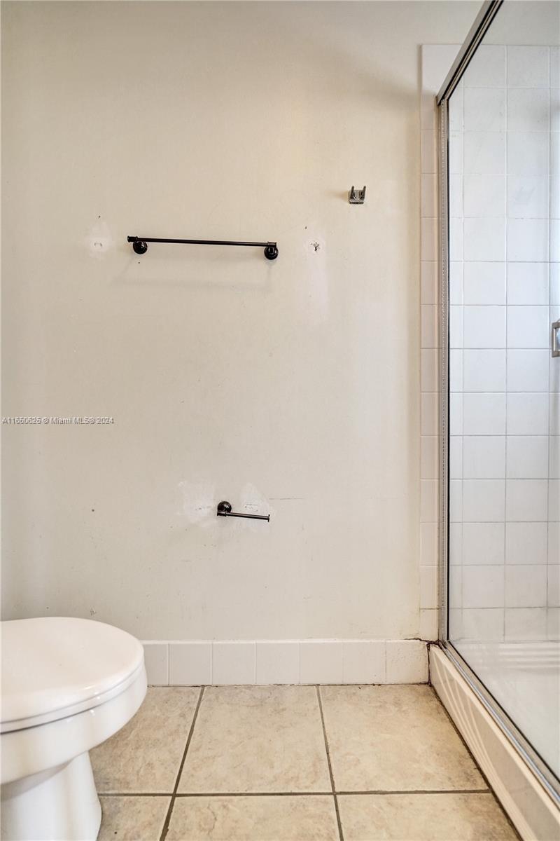 6073 Spring Isles Boulevard Lake Worth, FL 33463 - Photo 40 of 66 a bathroom with a toilet and a shower