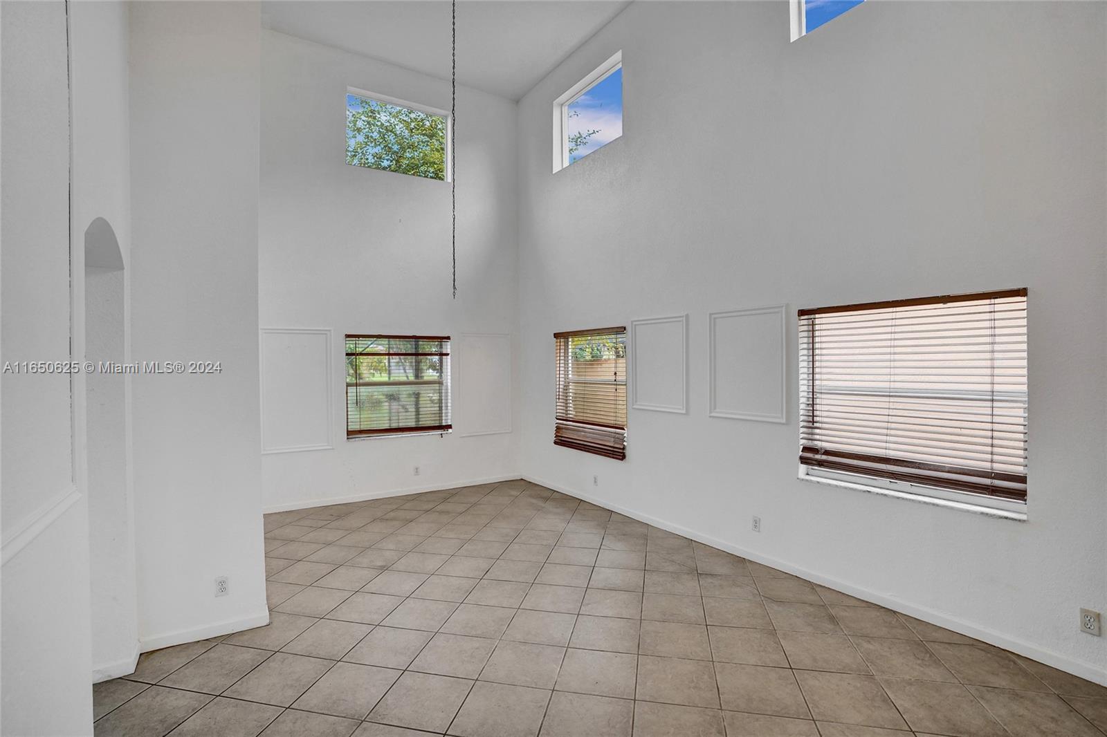 6073 Spring Isles Boulevard Lake Worth, FL 33463 - Photo 4 of 66 an empty room with windows