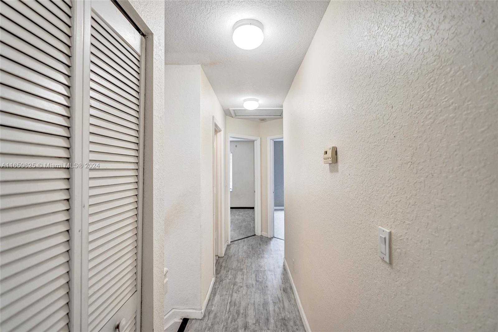 6073 Spring Isles Boulevard Lake Worth, FL 33463 - Photo 42 of 66 a view of a hallway with wooden shelves