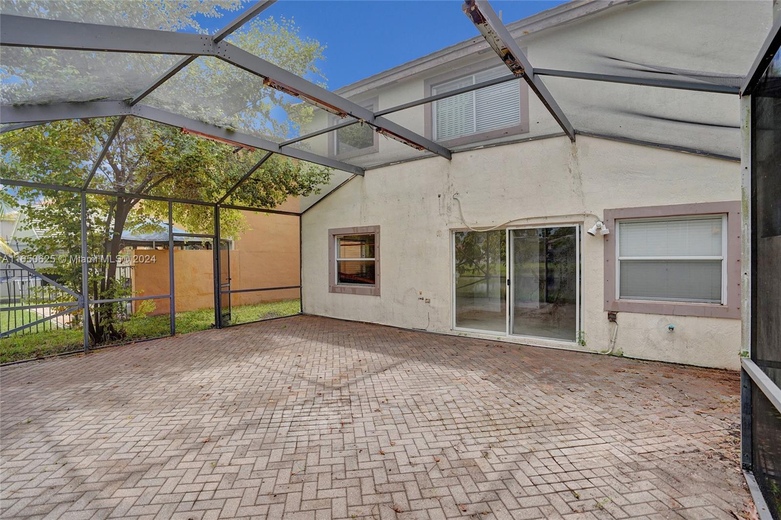 6073 Spring Isles Boulevard Lake Worth, FL 33463 - Photo 45 of 66 a view of a house with a backyard