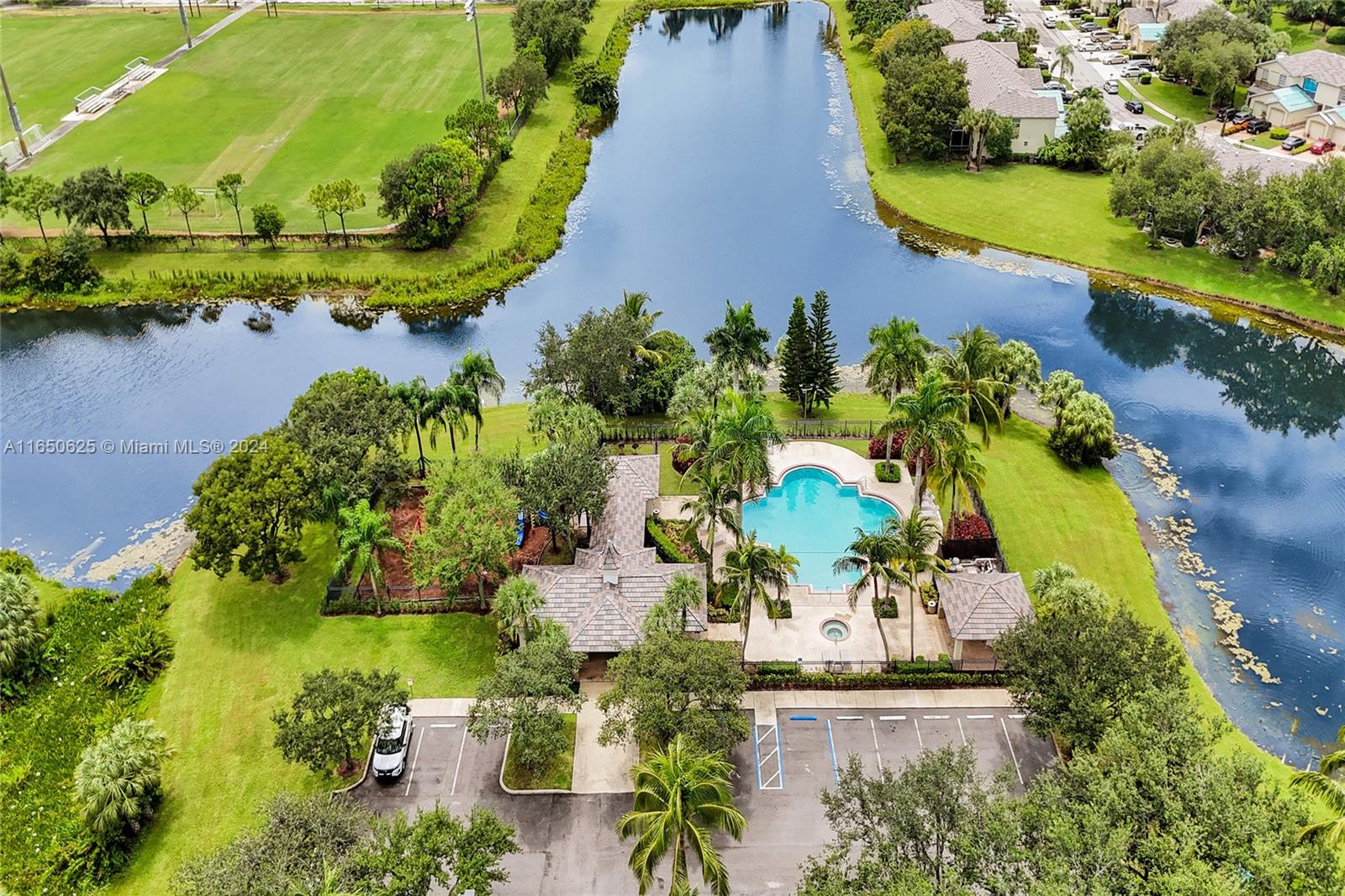 6073 Spring Isles Boulevard Lake Worth, FL 33463 - Photo 66 of 66 an aerial view of a house with a yard and lake view