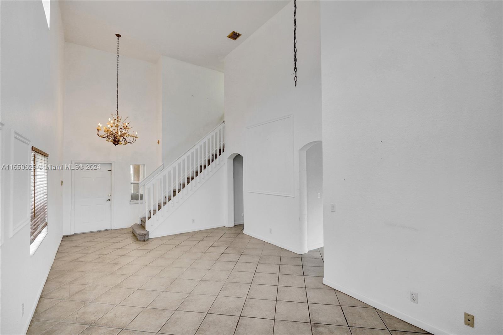 6073 Spring Isles Boulevard Lake Worth, FL 33463 - Photo 7 of 66 a view of a room with white walls and ceiling fan