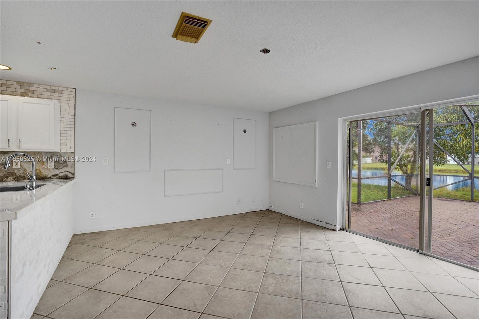 6073 Spring Isles Boulevard Lake Worth, FL 33463 - Photo 10 of 66 a view of an empty room and window