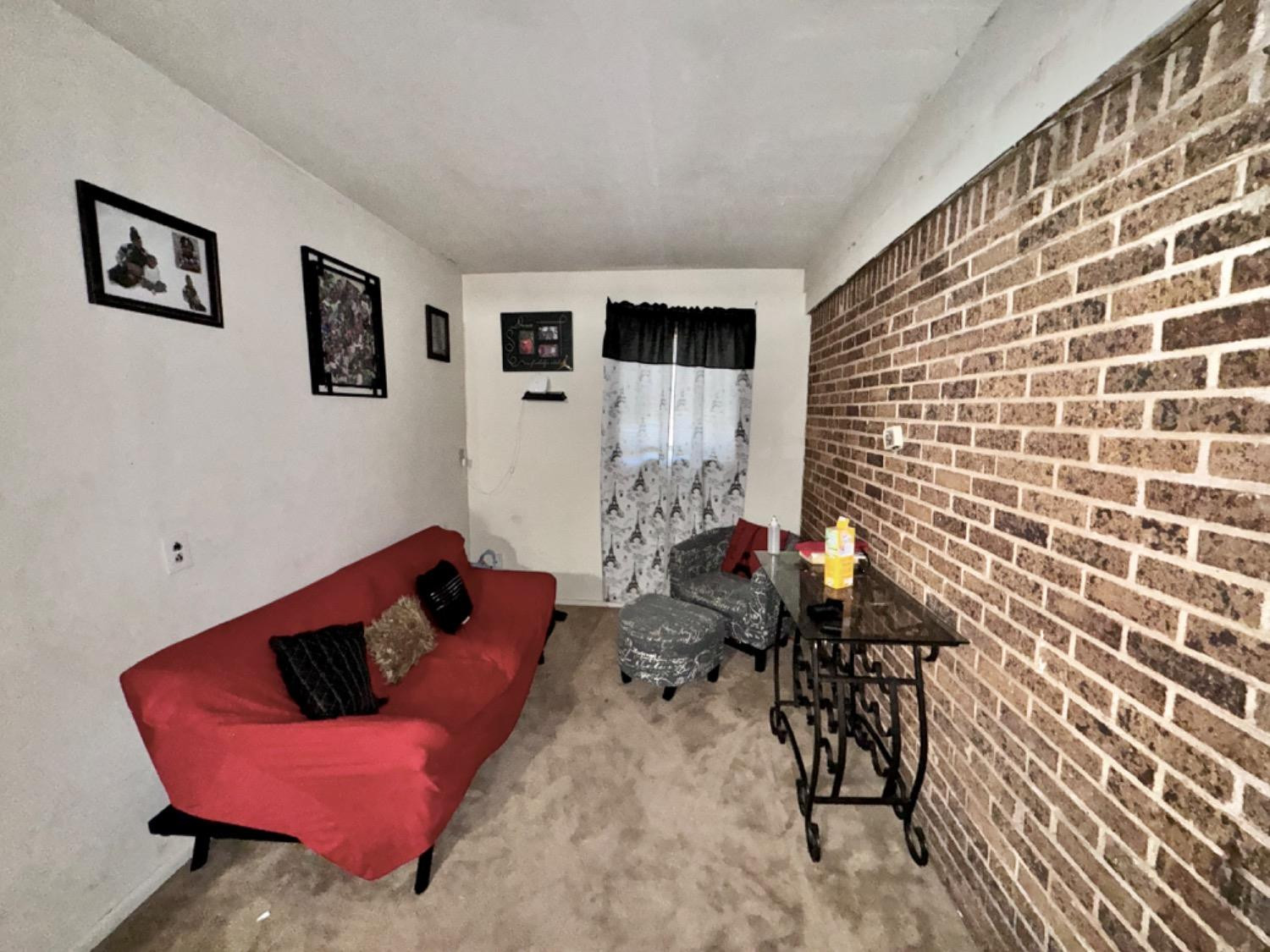 1901 28th Street Lubbock, TX 79411 - Photo 14 of 17 a living room with furniture and wooden floor