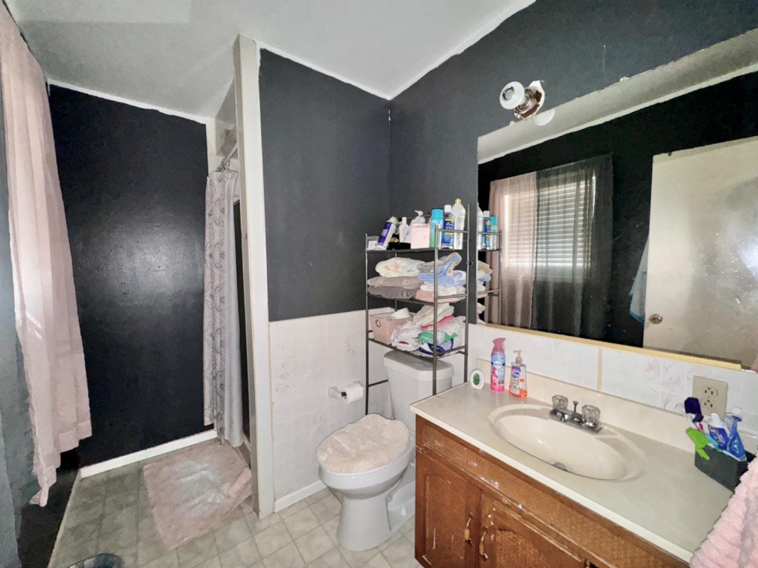 1901 28th Street Lubbock, TX 79411 - Photo 15 of 17 a bathroom with a sink toilet and shower