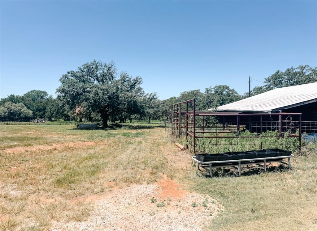 13610 Hwy 183 Rising Star Tx 76471 Rising Star, TX 76471 - Photo 25 of 39 View of yard featuring a view of rural / pastoral area, an outbuilding, and an exterior structure