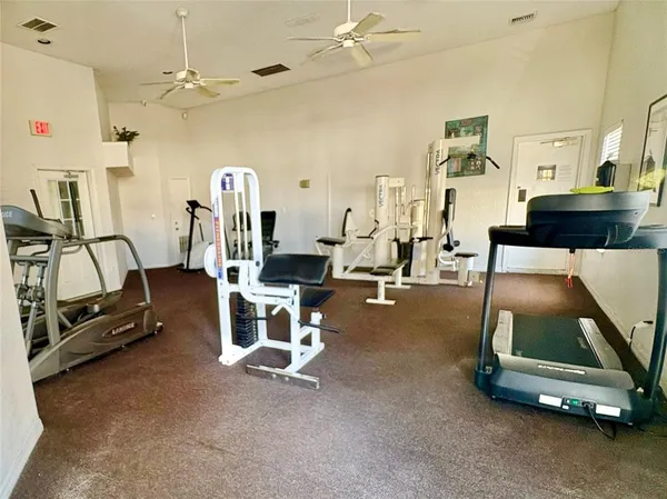 a room with gym equipment and windows