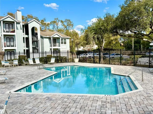 a view of a swimming pool with a lounge chairs