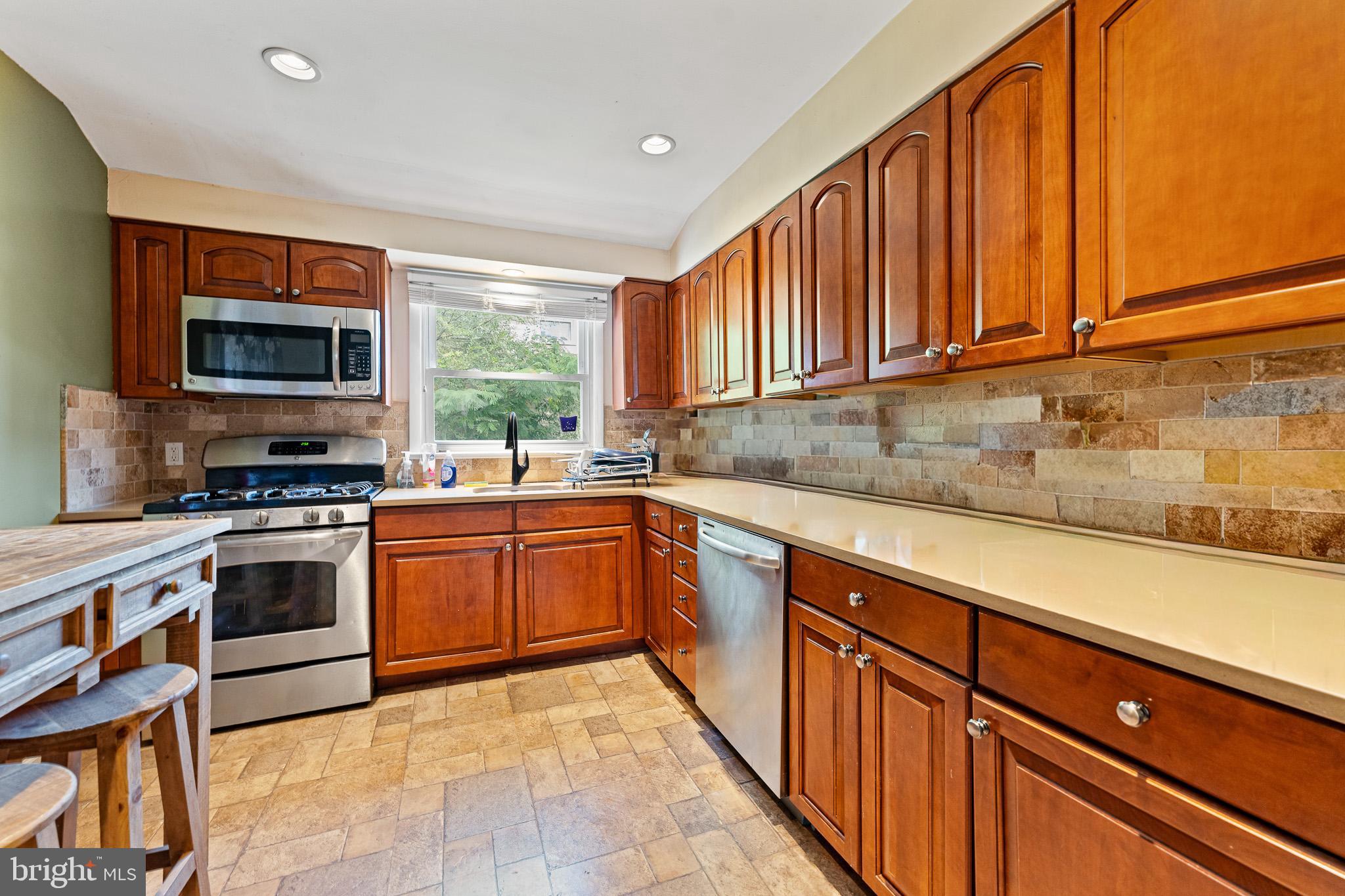 2305 Andover Road Cinnaminson, NJ 08077 - Photo 11 of 31 a kitchen with stainless steel appliances granite countertop wooden cabinets a stove top oven a sink and dishwasher