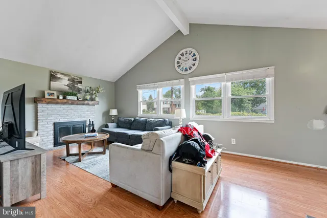 a living room with fireplace furniture and a window