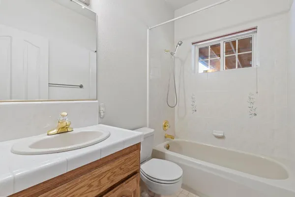 a kitchen with stainless steel appliances white cabinets granite counter tops and a window