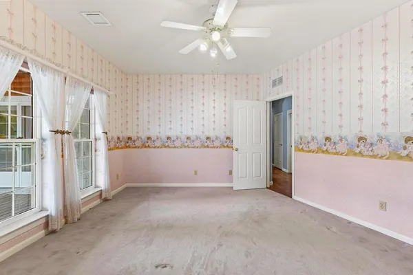 a view of a dining room with furniture and a chandelier fan