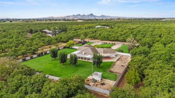 a front view of a house with a yard garage and outdoor seating