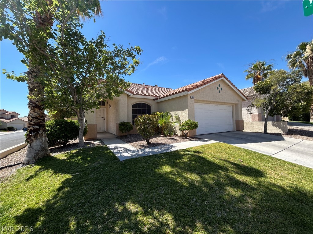 1840 Montvale Las Vegas, NV 89134 - Photo 3 of 31 A well-maintained stucco facade with a red tile roof welcomes you home.