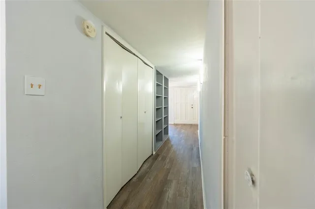 a view of hallway with wooden floor