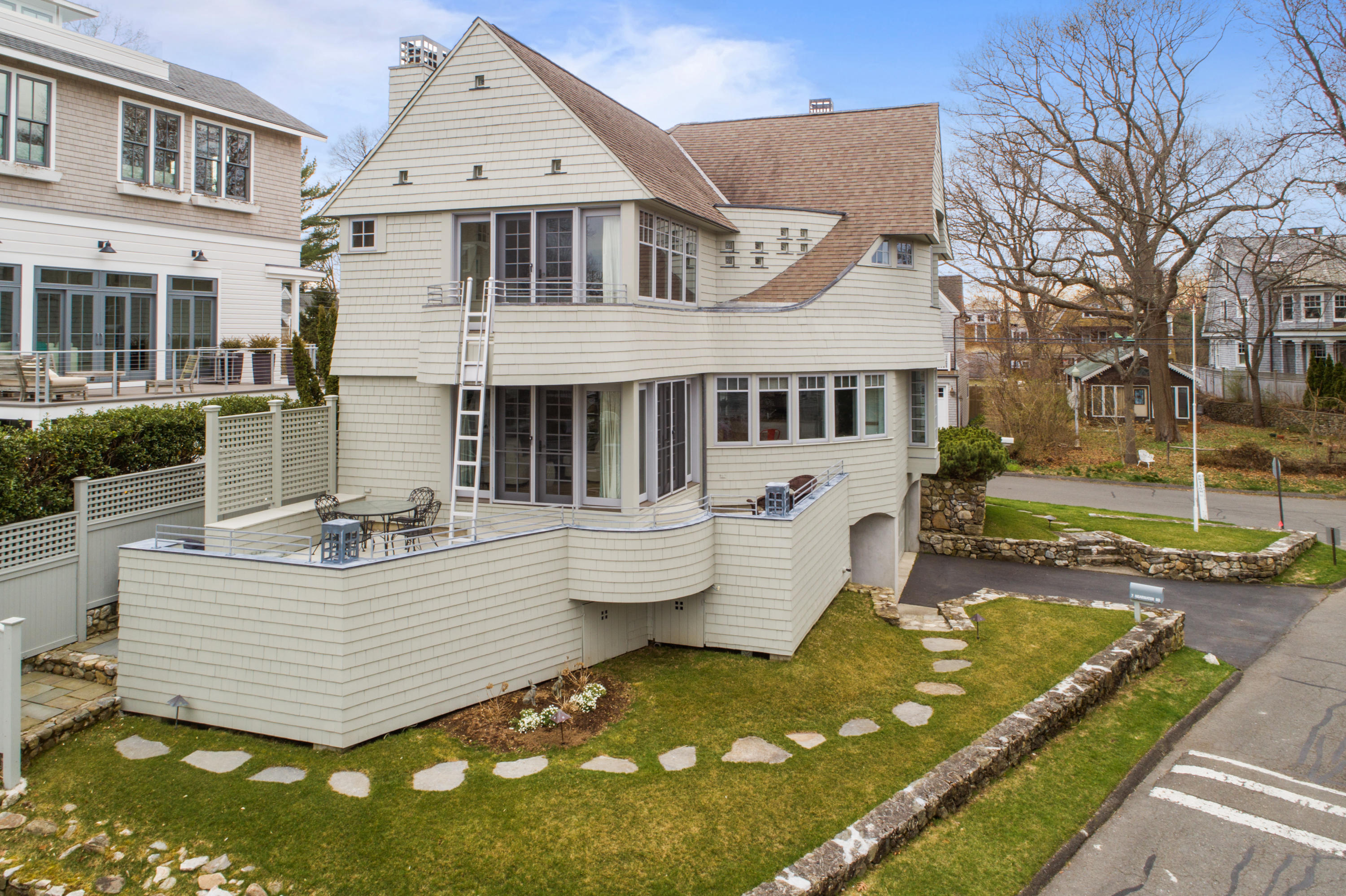 7 Nearwater Road Norwalk, CT 06853 - Photo 17 of 25 a view of a white house with a yard patio and fire pit