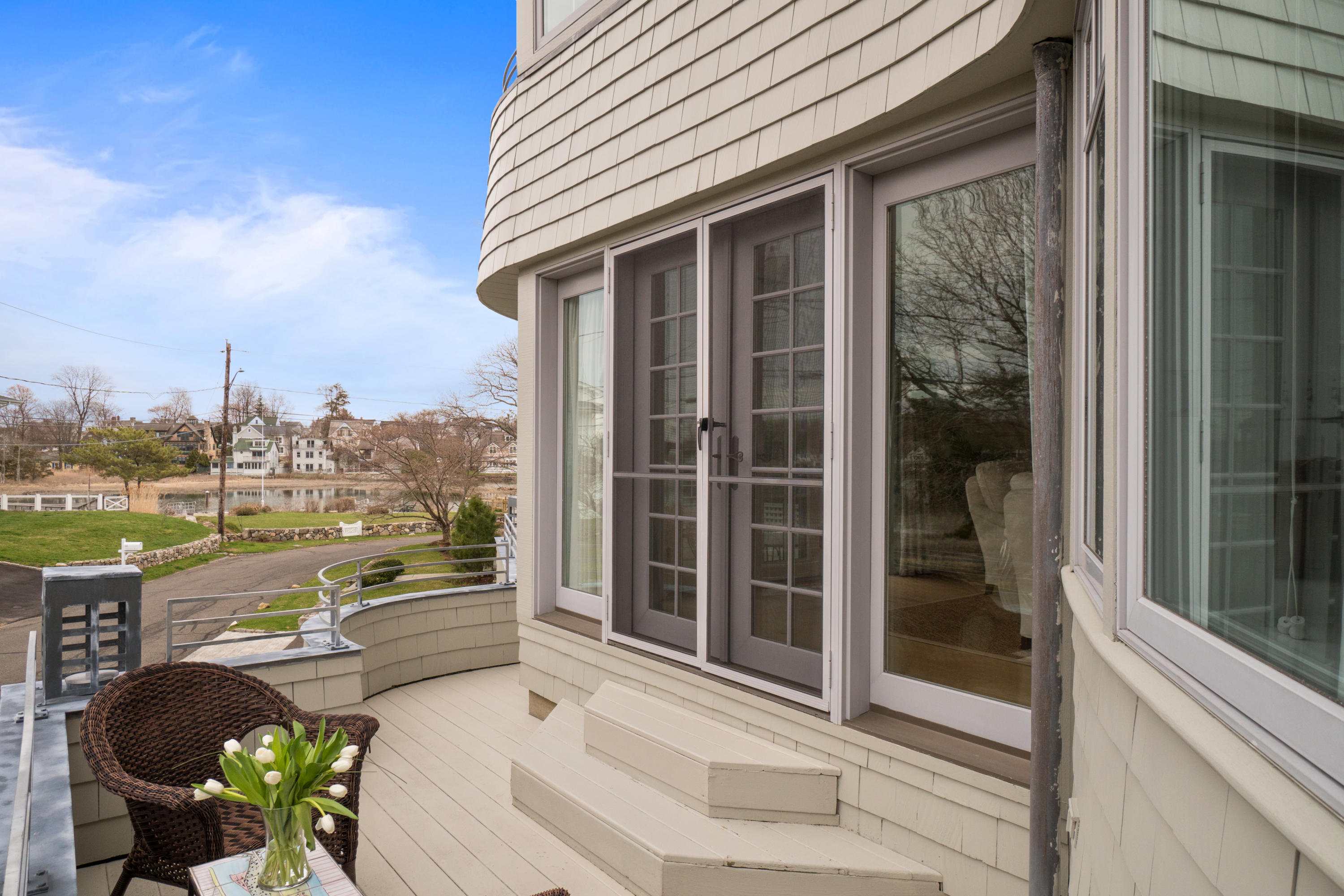 7 Nearwater Road Norwalk, CT 06853 - Photo 20 of 25 a view of a balcony with couches potted plants and floor to ceiling window