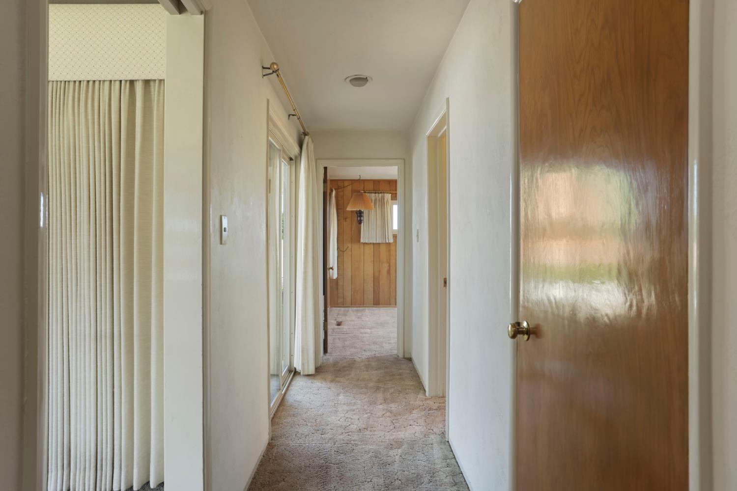 2465 Vernalis Road Tracy, CA 95304 - Photo 17 of 55 a view of a hallway with a wooden door