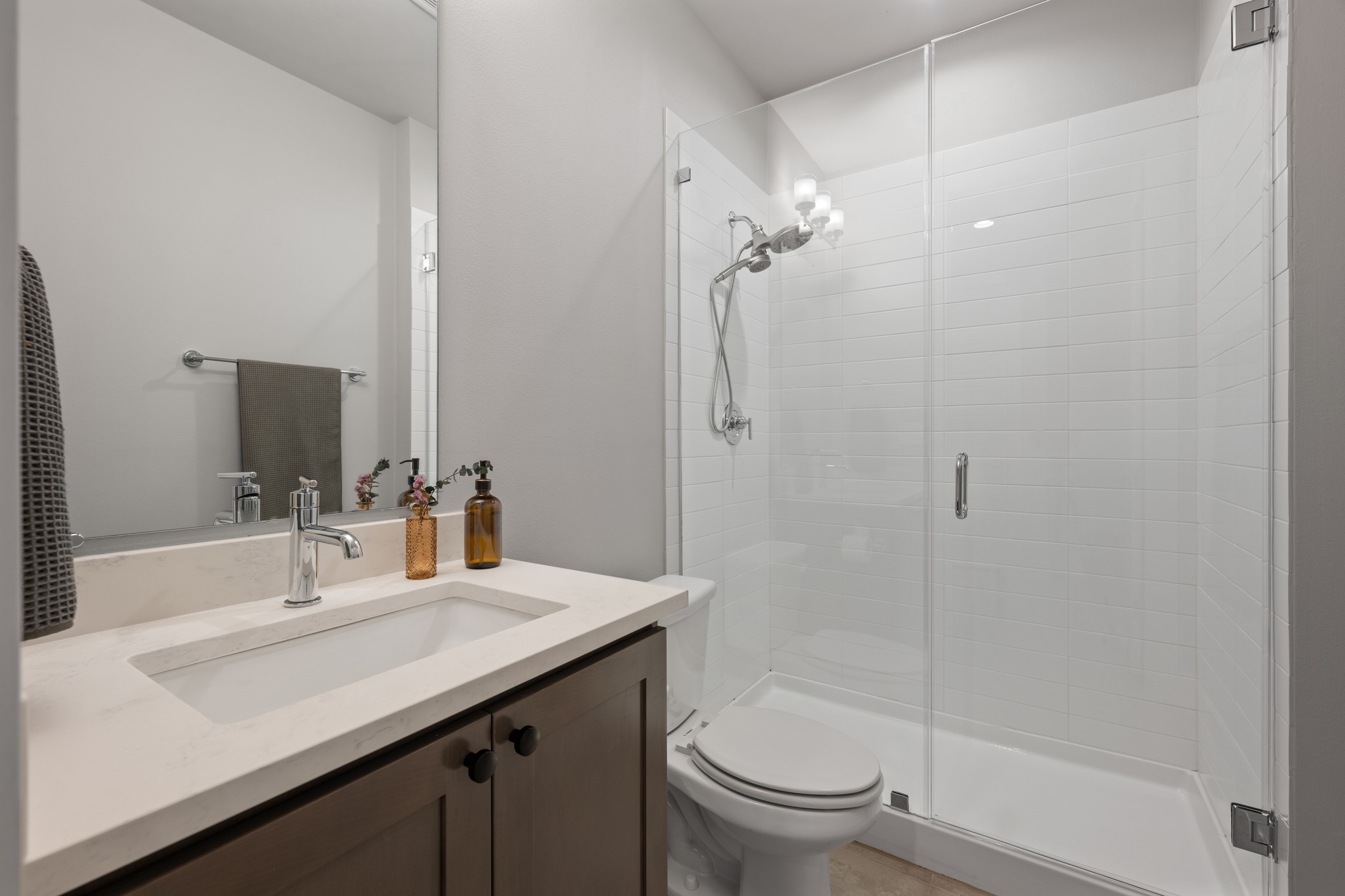 4515 Unity Circle Austin, TX 78731 - Photo 6 of 37 A glass-enclosed walk-in shower highlights this modern full bathroom featuring clean lines.