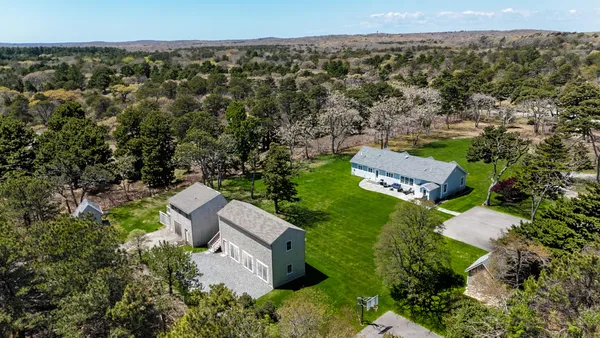 an aerial view of a house with a yard