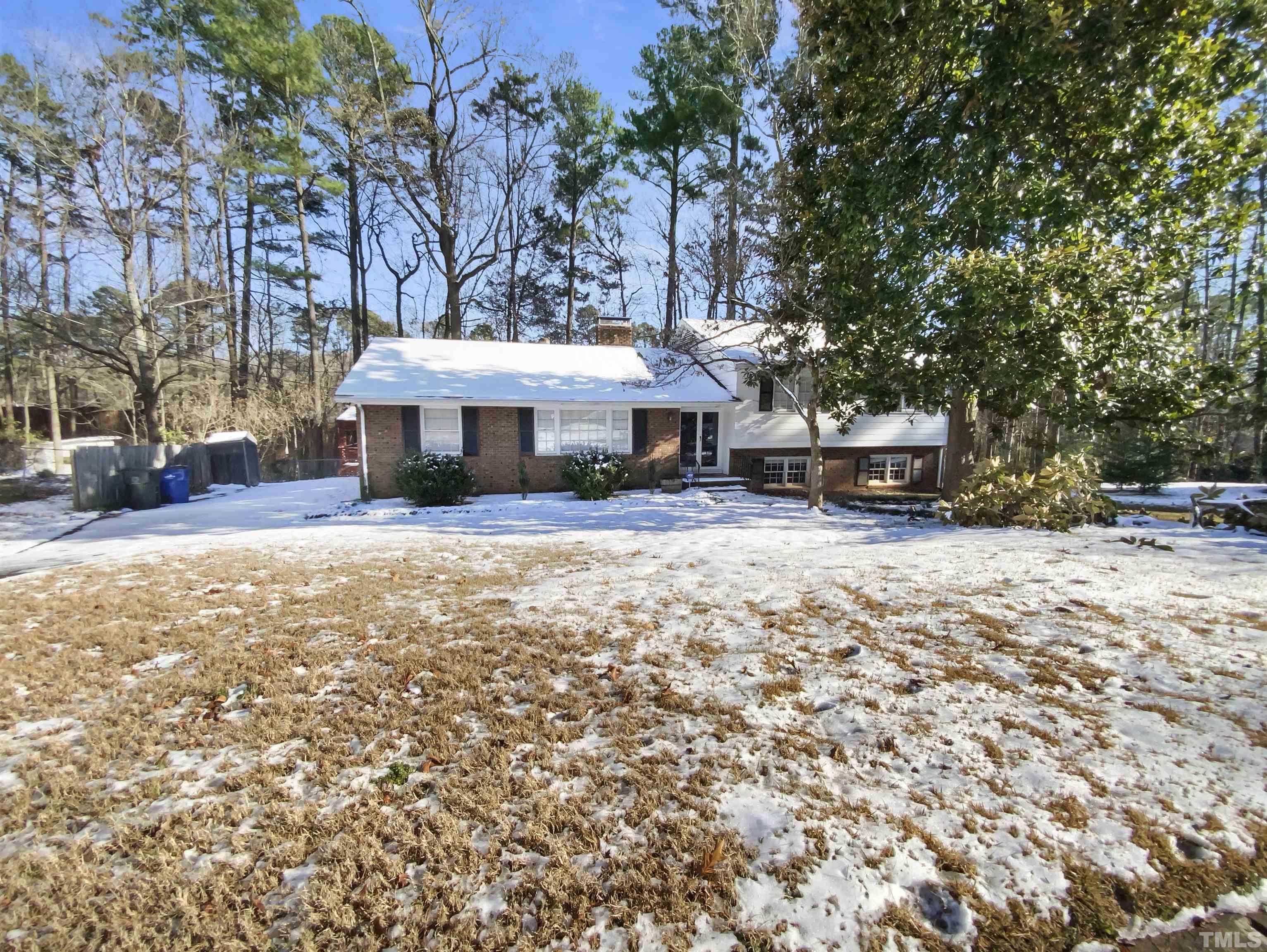 3200 Caldwell Drive Raleigh, NC 27607 - Photo 1 of 19 a view of a house with a yard covered in snow