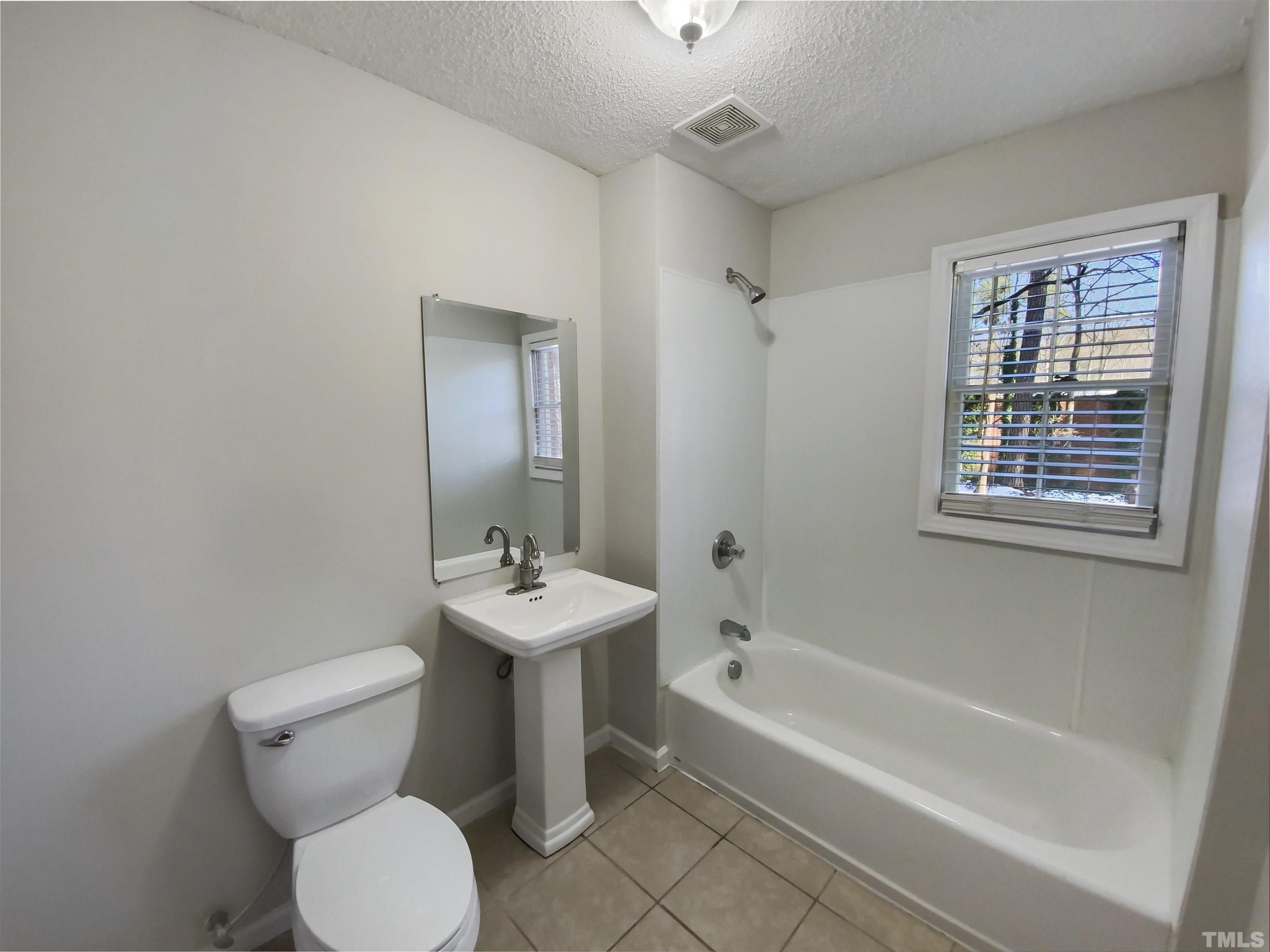 3200 Caldwell Drive Raleigh, NC 27607 - Photo 15 of 19 a white toilet sitting next to a bath tub