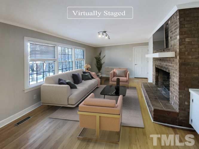 3200 Caldwell Drive Raleigh, NC 27607 - Photo 2 of 19 a living room with furniture and a fireplace