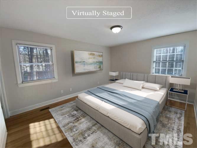 3200 Caldwell Drive Raleigh, NC 27607 - Photo 6 of 19 a bedroom with a bed and wooden floor