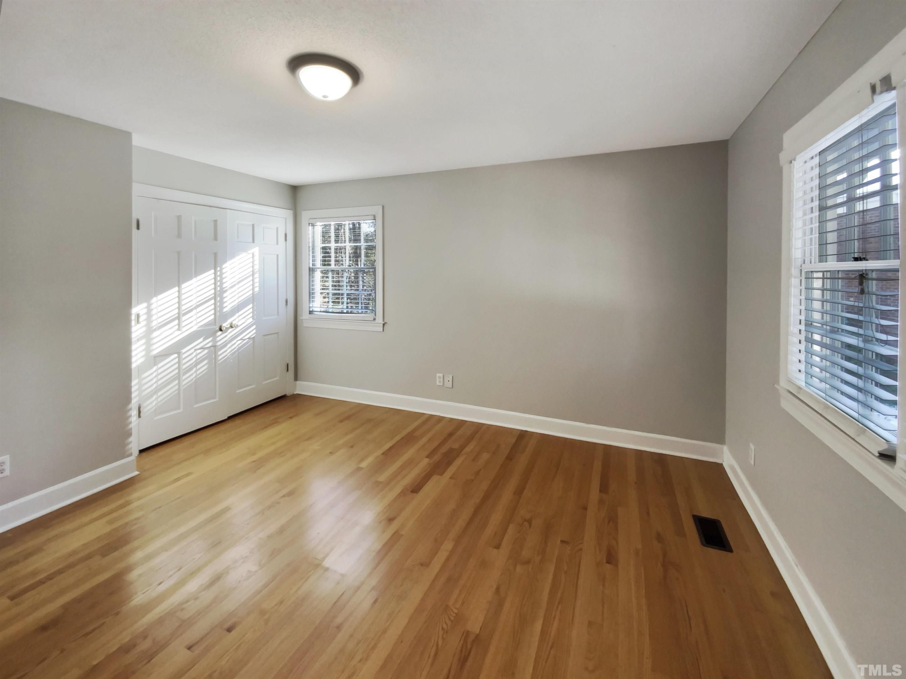3200 Caldwell Drive Raleigh, NC 27607 - Photo 8 of 19 an empty room with wooden floor and windows